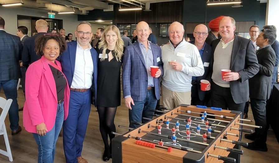 Alex Danzinger with colleagues at a Foosball technology community event