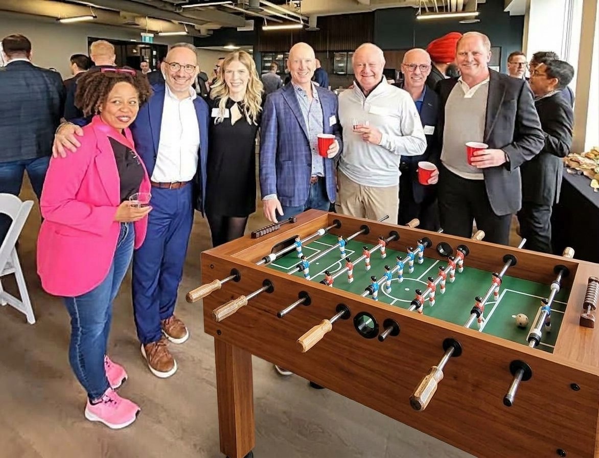 Alex Danzinger with colleagues at a Foosball technology community event